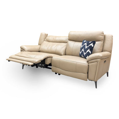 Side profile of the cream leather sofa, showing the modern open-base look and slender metal leg detail.