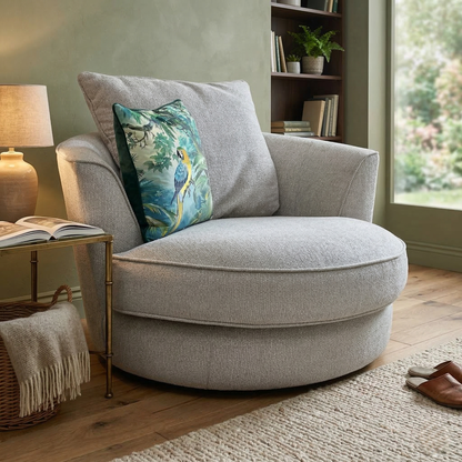 Living room of the silver fabric swivel chair highlighting its spacious 115cm width and indulgent cushioning.