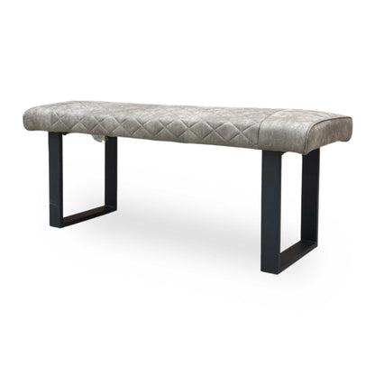 Side profile of the Warrior dining bench emphasizing the ergonomic seat thickness and angled metal leg frame.