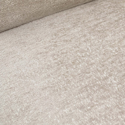 Close-up of the sand-colored fabric, showcasing the pinched seam tailoring along the edges and the central horizontal backrest groove.