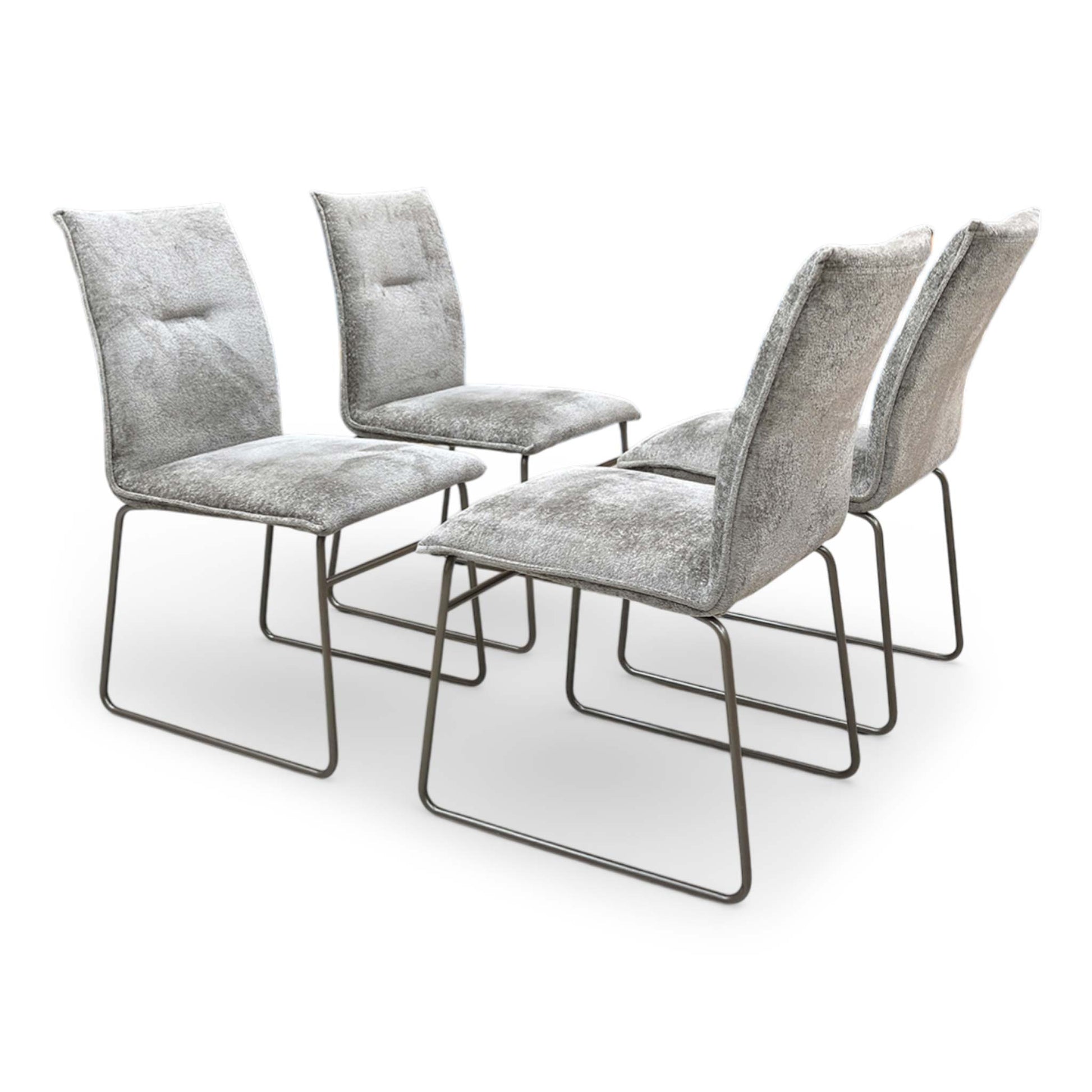 Side view of a Maya dining chair, showcasing the sleek profile of the seat and the architectural tubular metal frame.