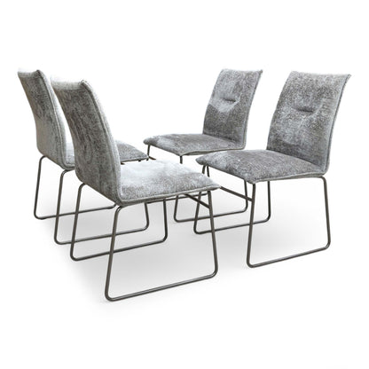 Full view of Set of four Connubia Maya dining chairs upholstered in taupe fabric with contemporary lava-finished metal ski-style legs.