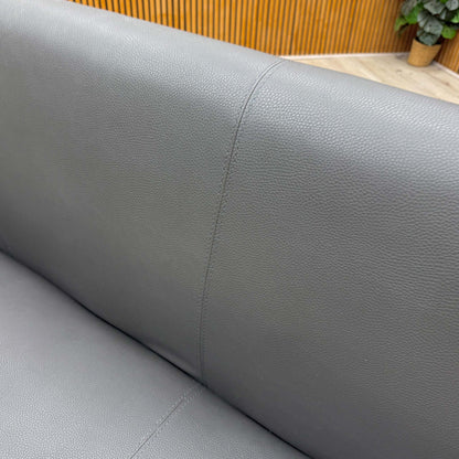 Close-up of the stain-resistant grey faux leather upholstery, emphasizing its soft and practical finish.