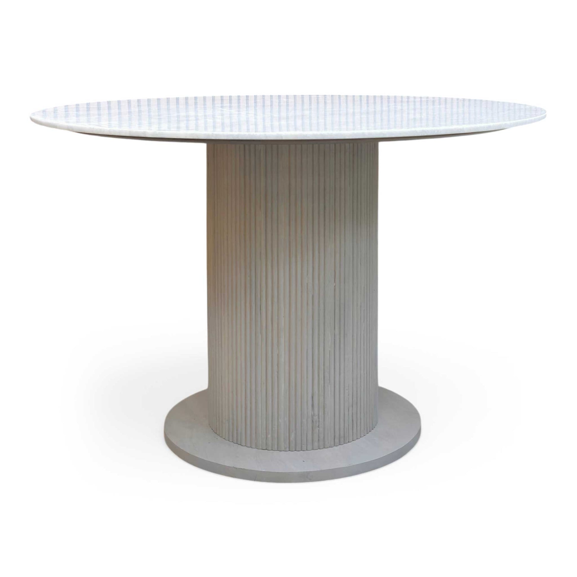 Full view of the Aimar 115cm round dining table featuring a white marble-effect ceramic top and a modern black metal pedestal base.