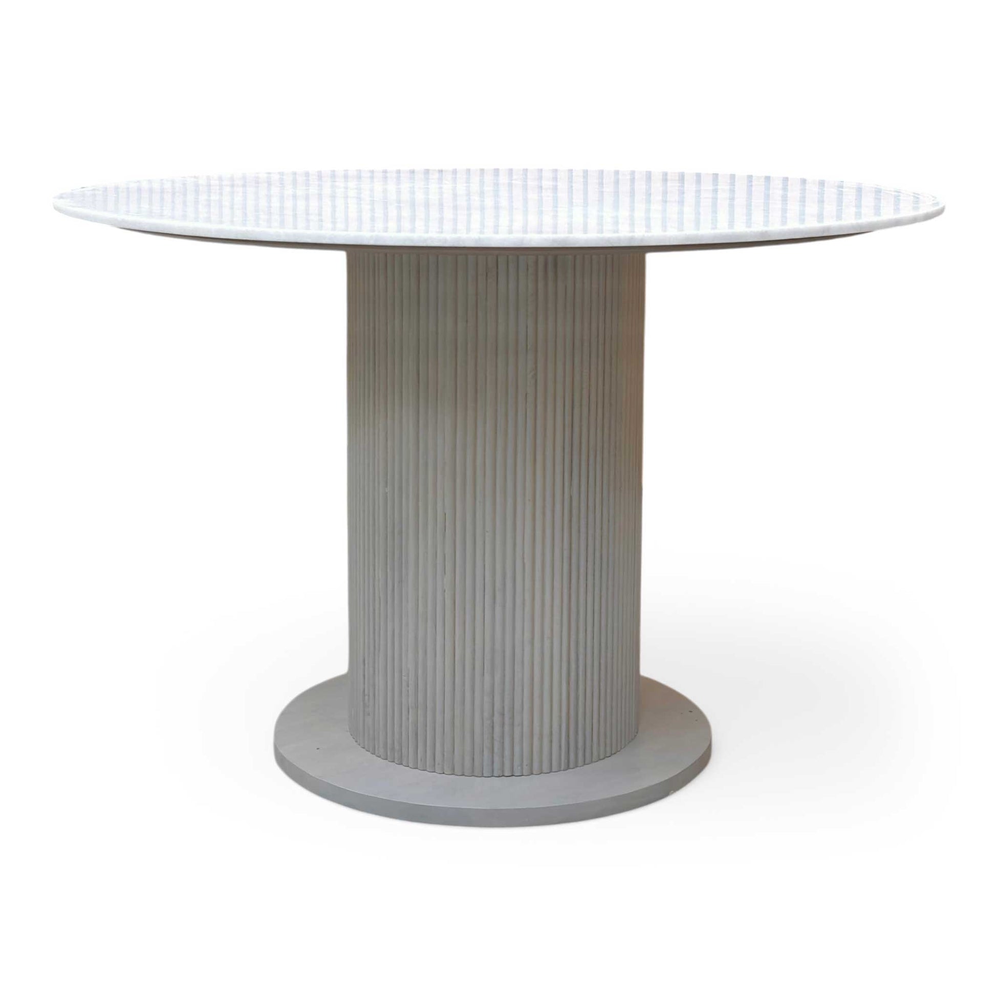 Side profile of the Aimar table, emphasizing the slim, contemporary profile of the ceramic-on-glass top and the architectural base.