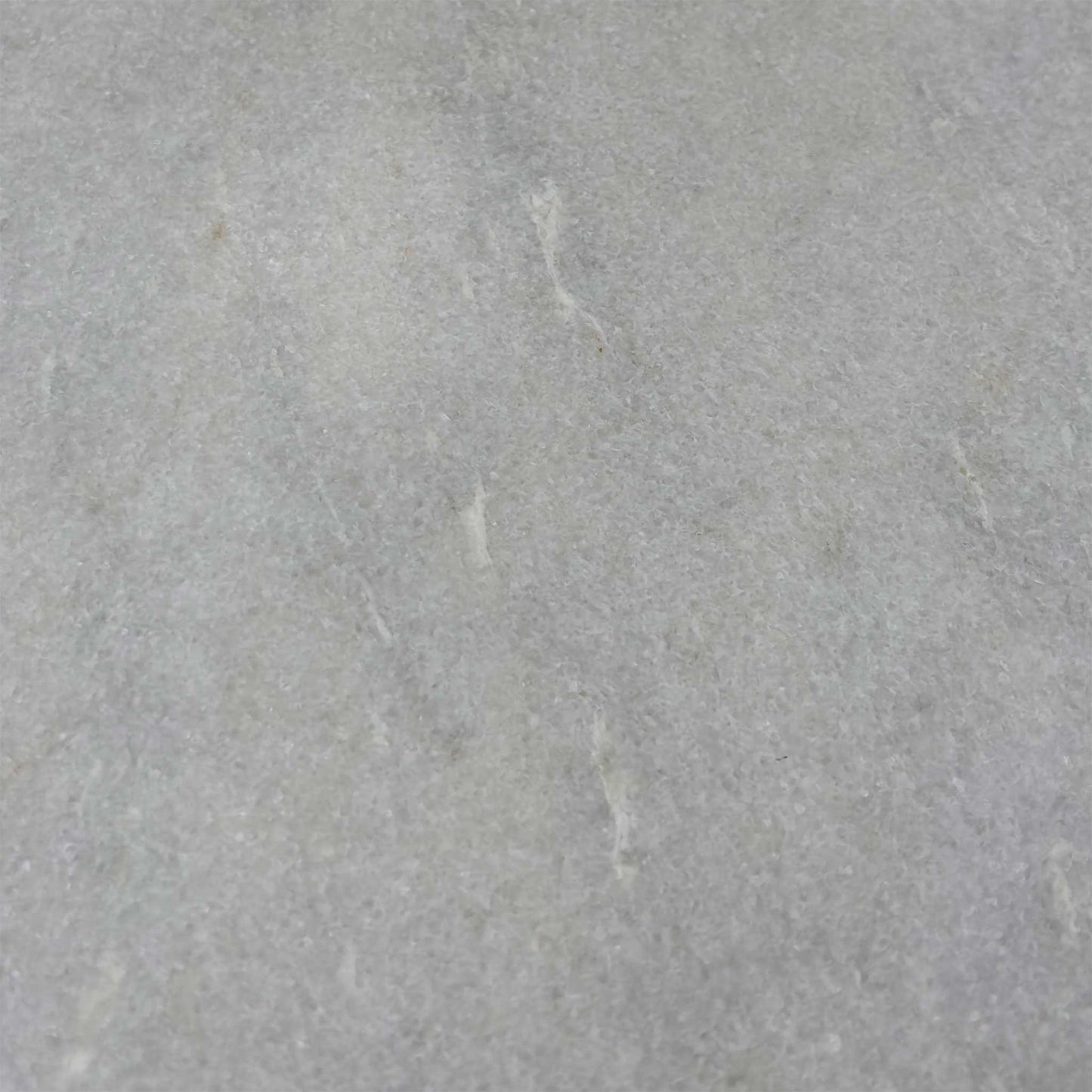 Close-up of the white ceramic surface, highlighting the subtle grey marble veining and the durable, easy-to-clean matte finish.