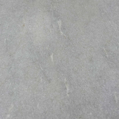 Close-up of the white ceramic surface, highlighting the subtle grey marble veining and the durable, easy-to-clean matte finish.