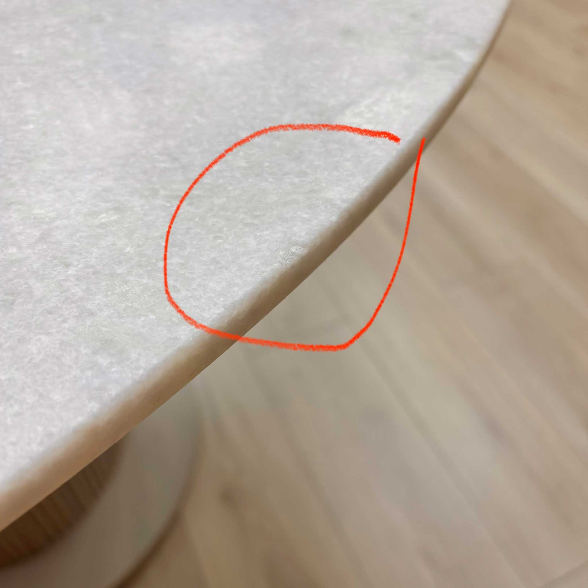 Close-up of the white ceramic surface, highlighting the damage.