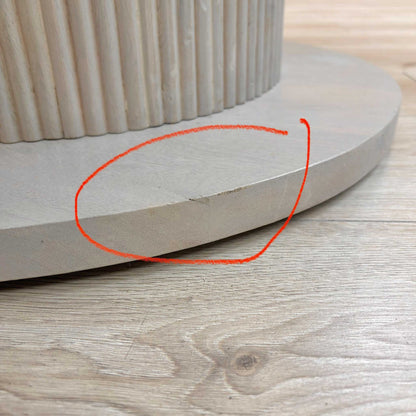 Close-up of the white ceramic surface, highlighting the damage.