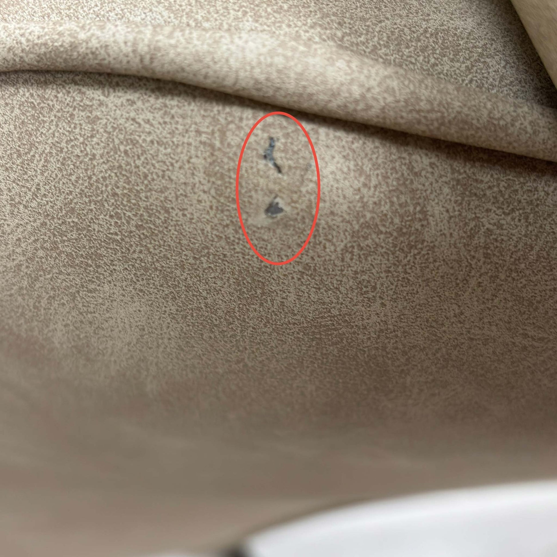 Close up view of damage on the upholstery.
