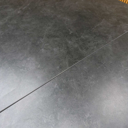 Close-up of the asymmetric black powder-coated metal base, showcasing the modern architectural design.