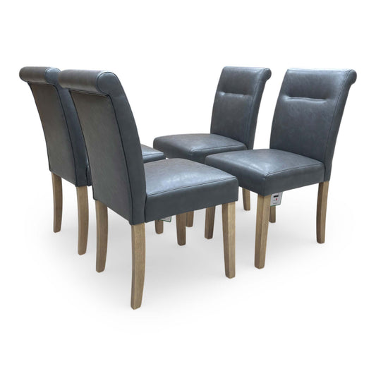 Full view of Set of four Lewis roll-back dining chairs in dark grey faux leather with elegant button-back detailing.