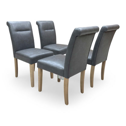 Side profile of the roll-back dining chair illustrating the gentle curve of the backrest and sturdy dark legs.