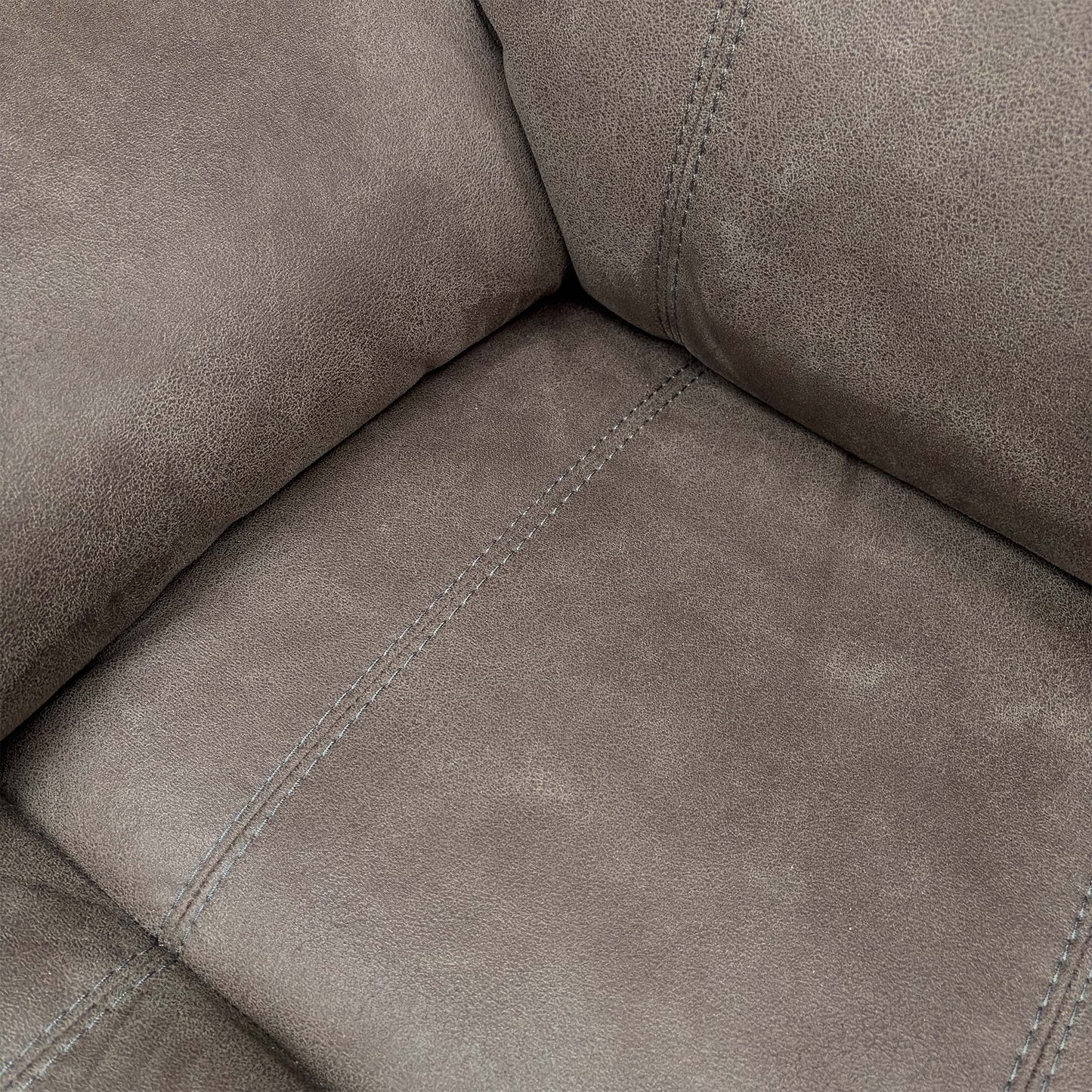 Close-up of the grey suede fabric texture, illustrating the soft-touch finish and high-quality tailoring of the upholstery.