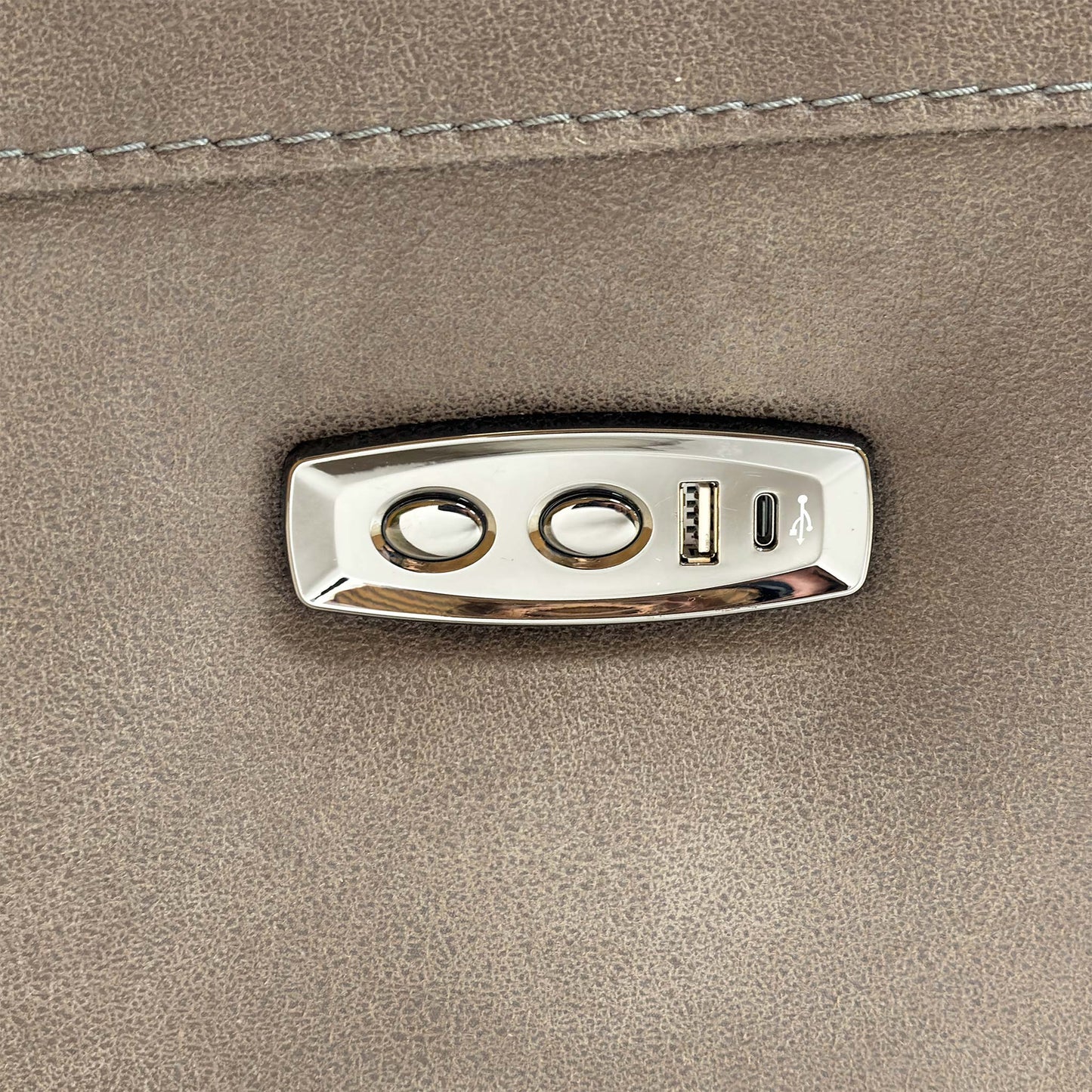 Detailed view of the integrated power recliner controls and USB charging port on the side of the armrest.