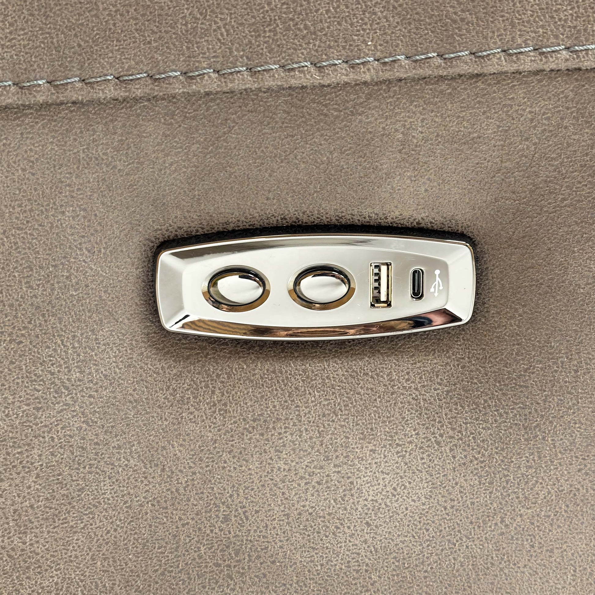 Detailed view of the integrated power recliner controls and USB charging port on the side of the armrest.