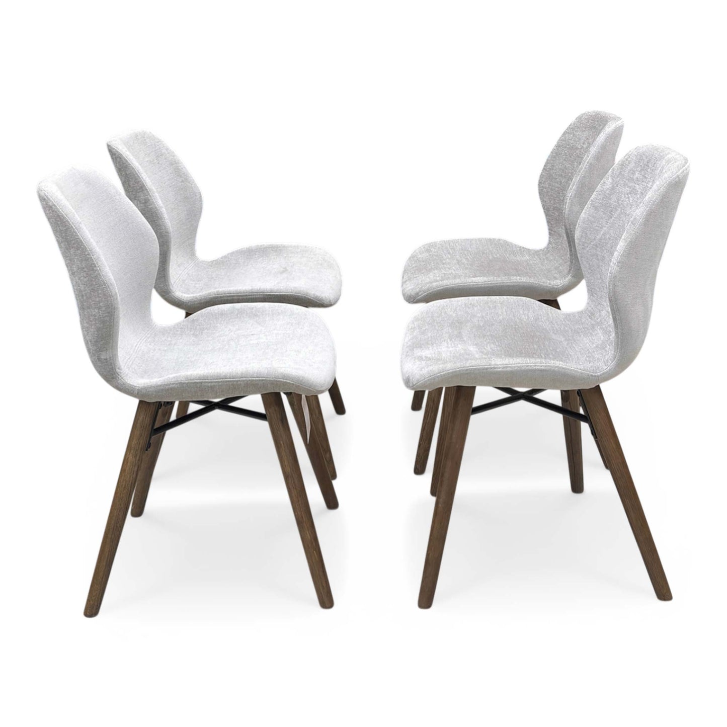 Side profile of the Stockholm chair, showcasing the elegant curvature and handmade craftsmanship of the upholstered frame.