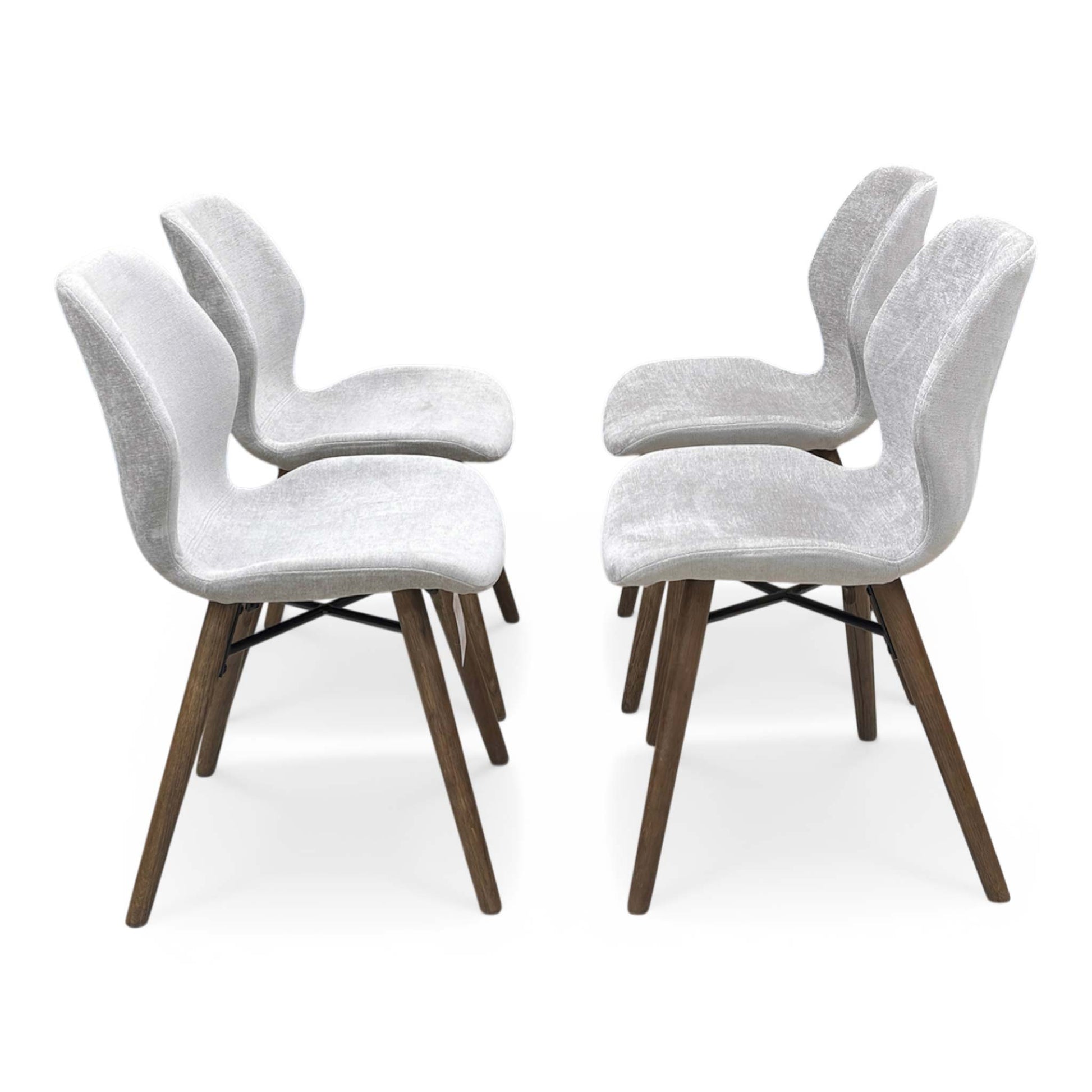 Side profile of the Stockholm chair, showcasing the elegant curvature and handmade craftsmanship of the upholstered frame.