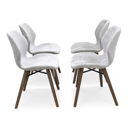 Side profile of the Stockholm chair, showcasing the elegant curvature and handmade craftsmanship of the upholstered frame.