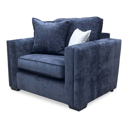 Side profile of the Chelsea love chair, showcasing the depth of the seat and the classic back cushion profile.