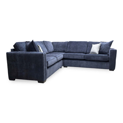 Side perspective of the Chelsea corner sofa, displaying the classic high-back cushions and uniform symmetrical design.