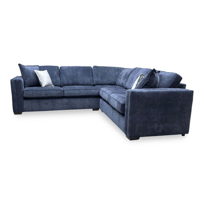 Side perspective of the Chelsea corner sofa, displaying the classic high-back cushions and uniform symmetrical design.