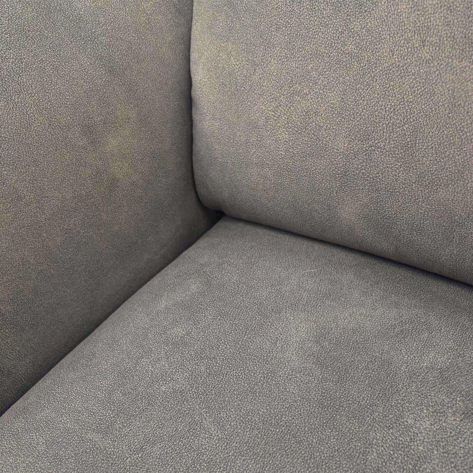 Close-up of the Dexter mocha grey fabric, showing the soft-touch weave and detailed geometric stitching patterns.