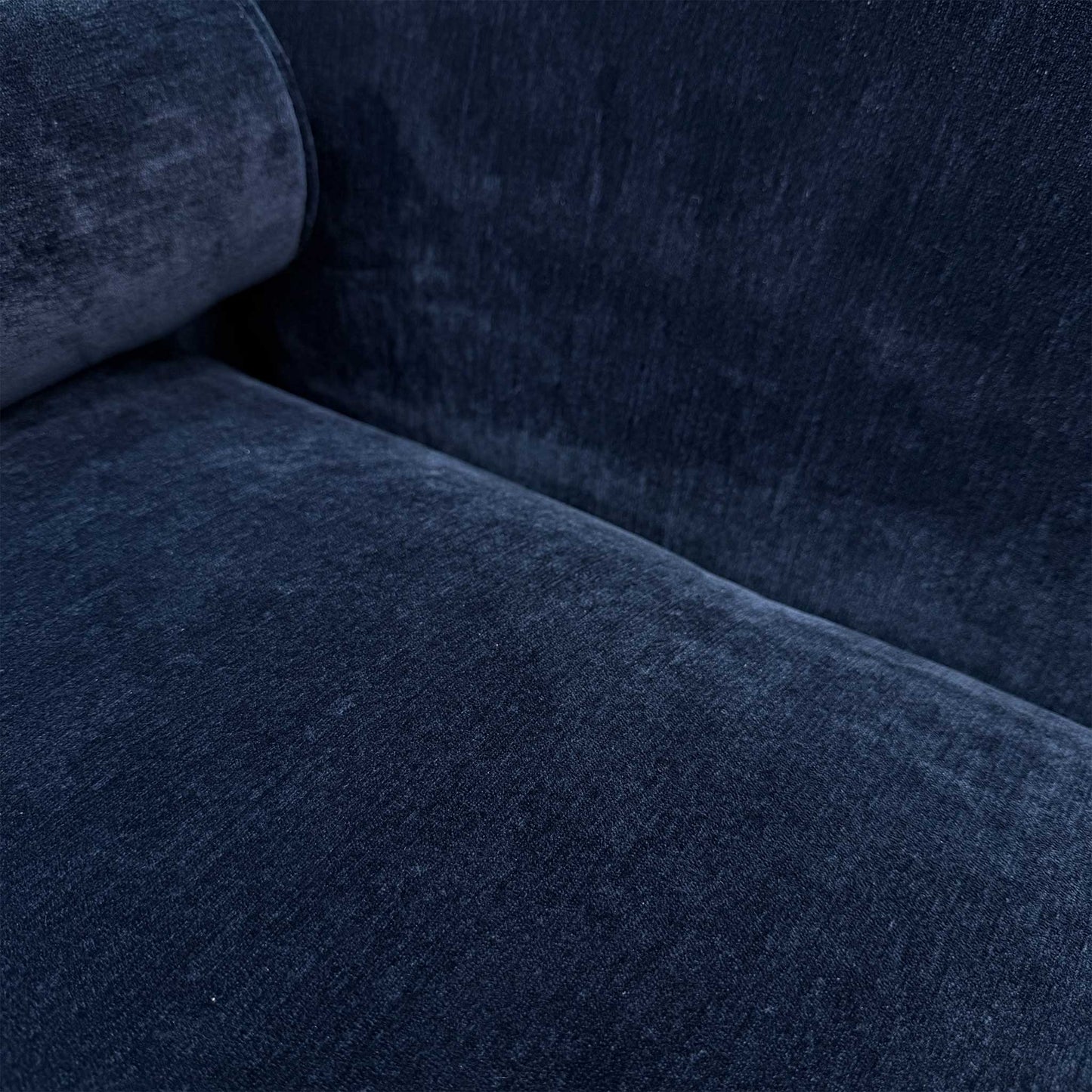 Close-up of the durable navy blue upholstery and bolster cushion detail on the Dame 4-seater sofa.