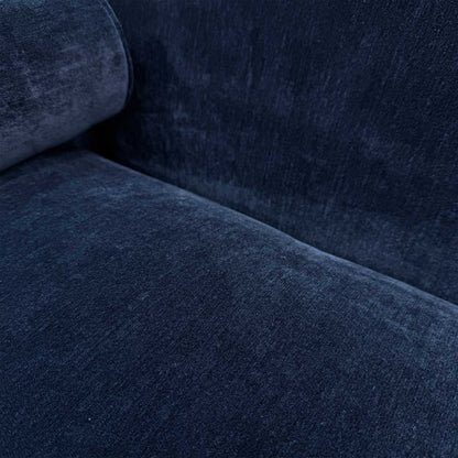 Close-up of the durable navy blue upholstery and bolster cushion detail on the Dame 4-seater sofa.