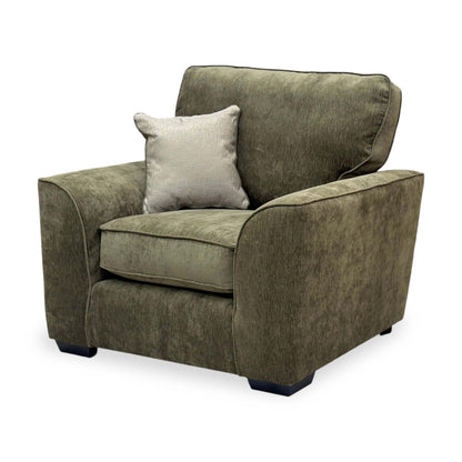Side profile of the Harvey armchair, displaying its deep seat cushions and sturdy wooden frame construction