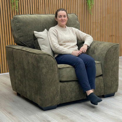 Front view of the olive green Harvey armchair, highlighting its modern silhouette.