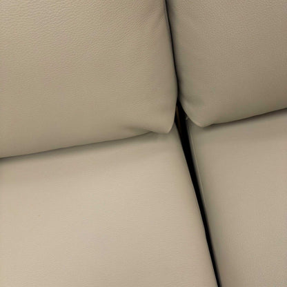 Close-up of the distinctive arm cushions and 100% premium leather upholstery.