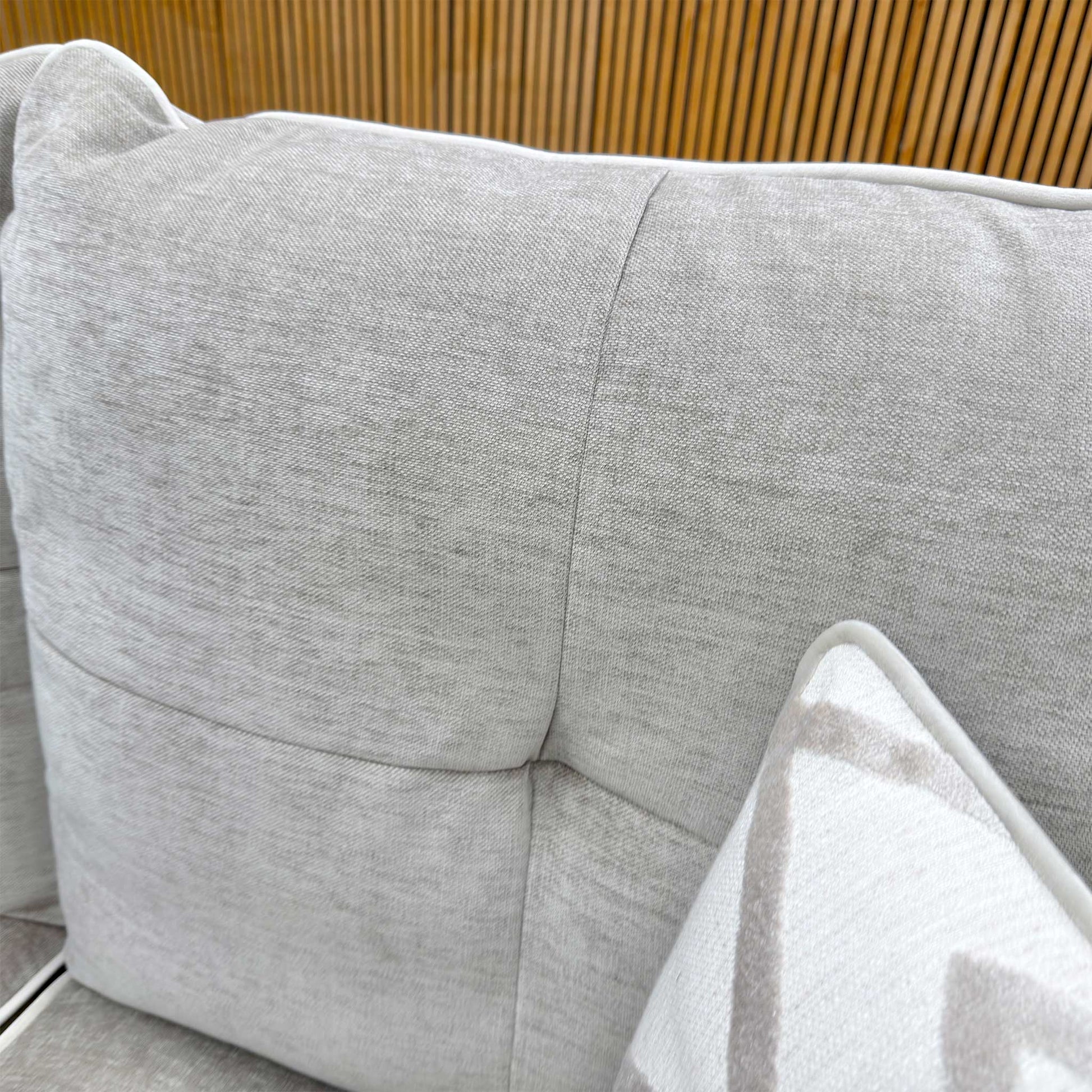 Detailed shot of the high-quality linen fabric texture and reversible fiber-filled back cushions.