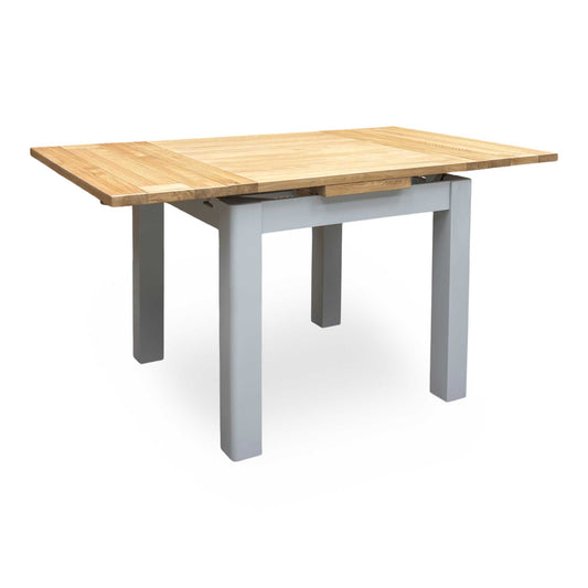 Full view of the ‘Lewis’ small extending dining table crafted from solid American oak, featuring a compact square design and a natural lacquered wood finish.