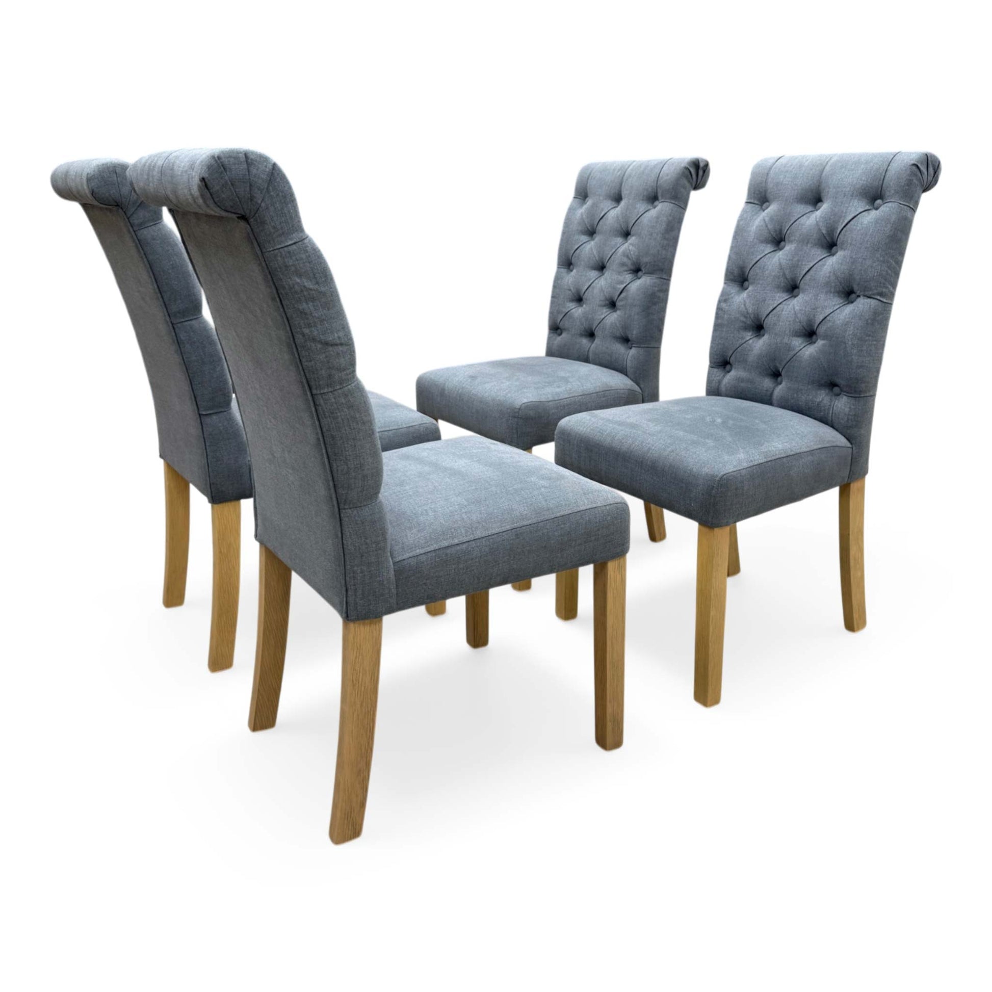 Full view of Set of four 'Hamilton' dining chairs in charcoal grey fabric, featuring a roll back design and button-tufted backrests.