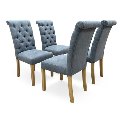 Side view of a single Hamilton dining chair showing the detailed button-tufting on the charcoal grey fabric backrest.