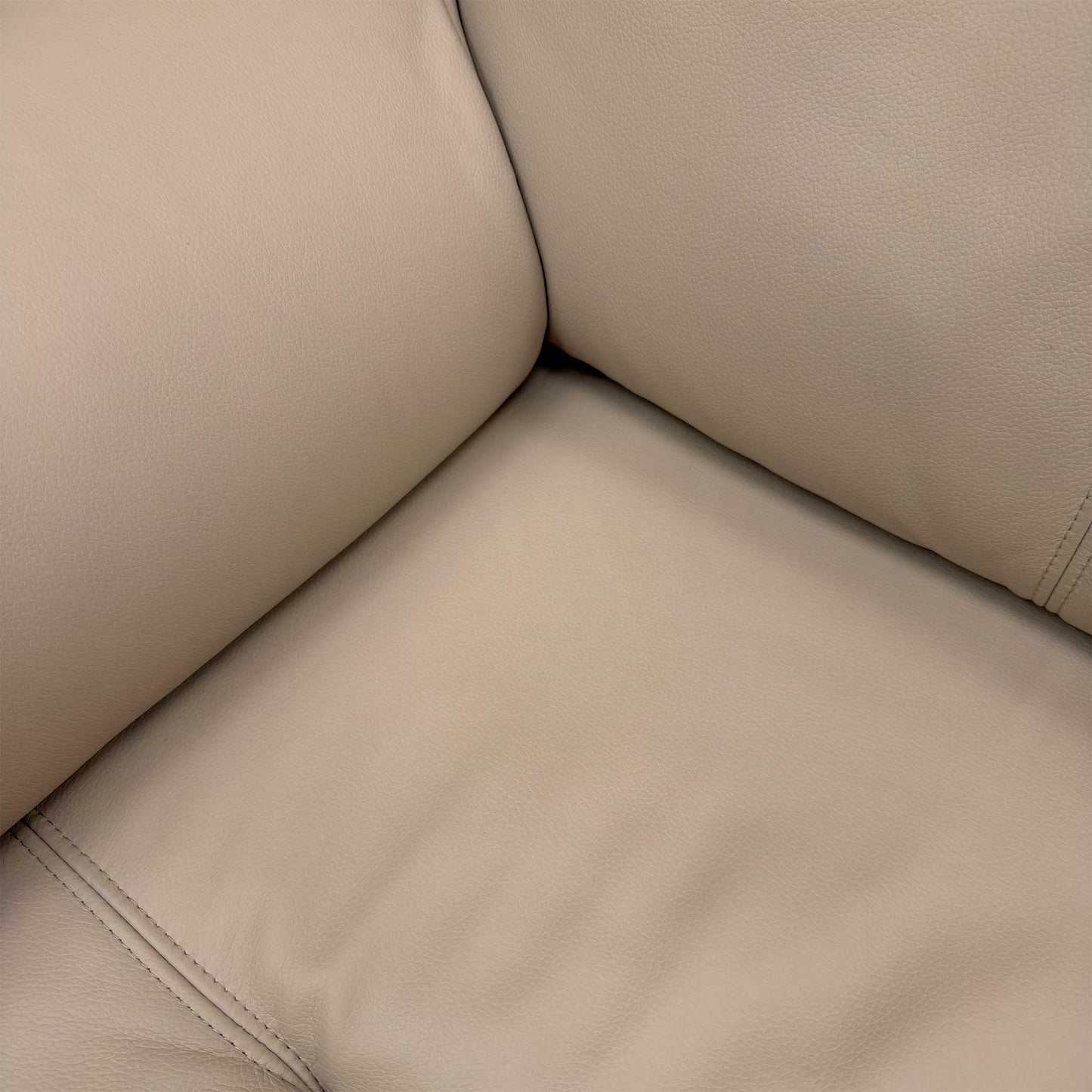 Close up view of the distinctive arm cushion design and premium Plaster Beige fabric upholstery.