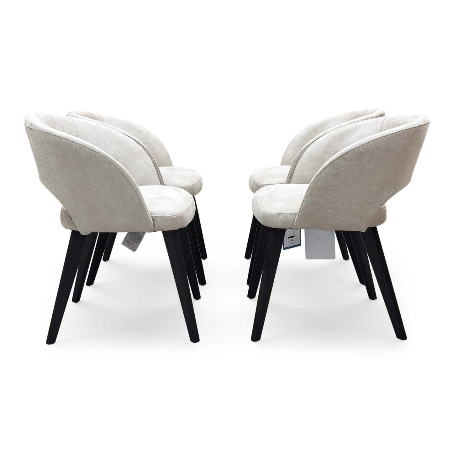 Front-facing view of a Goya dining chair, showcasing the understated glam style, comfortable low-back silhouette, and dense foam seat cushioning.