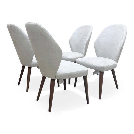 Full view of the Empire dining chair in Satin Light Grey fabric, featuring a tall supportive backrest and dark slender wooden legs.