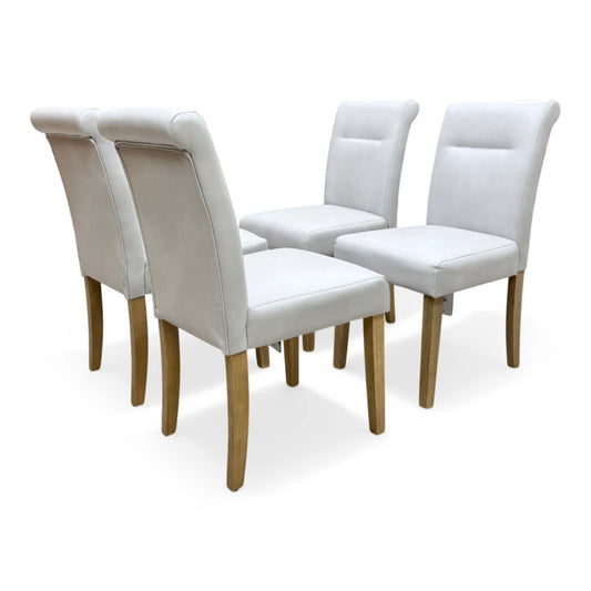 Full view profile of the Lewis dining chair in light grey faux leather with elegant button tufting and natural rubberwood legs.