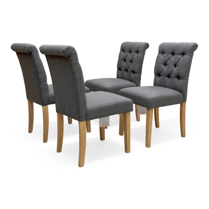 Full view of Set of 4 Lewis anthracite grey fabric dining chairs with roll back and button back design.