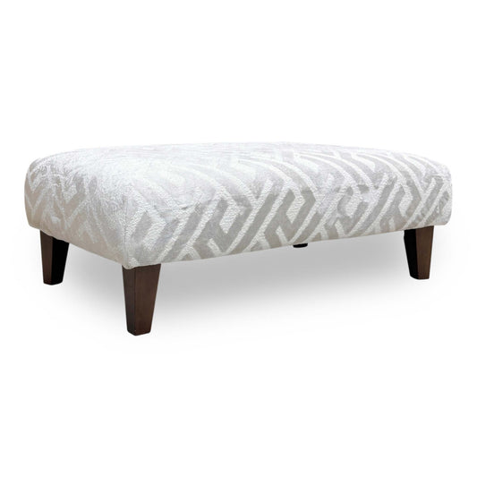 Full view of the ‘Tabitha’ bench footstool in a Natural patterned fabric, featuring a traditional rectangular design with deep button tufting and dark wood turned legs.