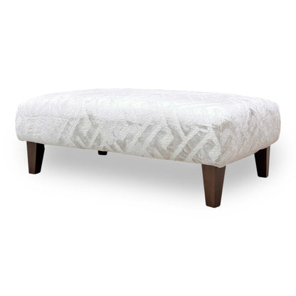 Side view of the ‘Tabitha’ Natural Patterned Footstool, demonstrating the fabric’s texture, the firm cushioned top, and the smooth movement of the casters.