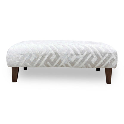 Front profile of the Tabitha bench, emphasizing the classic silhouette and the contrast between the patterned upholstery and the dark-stained legs.