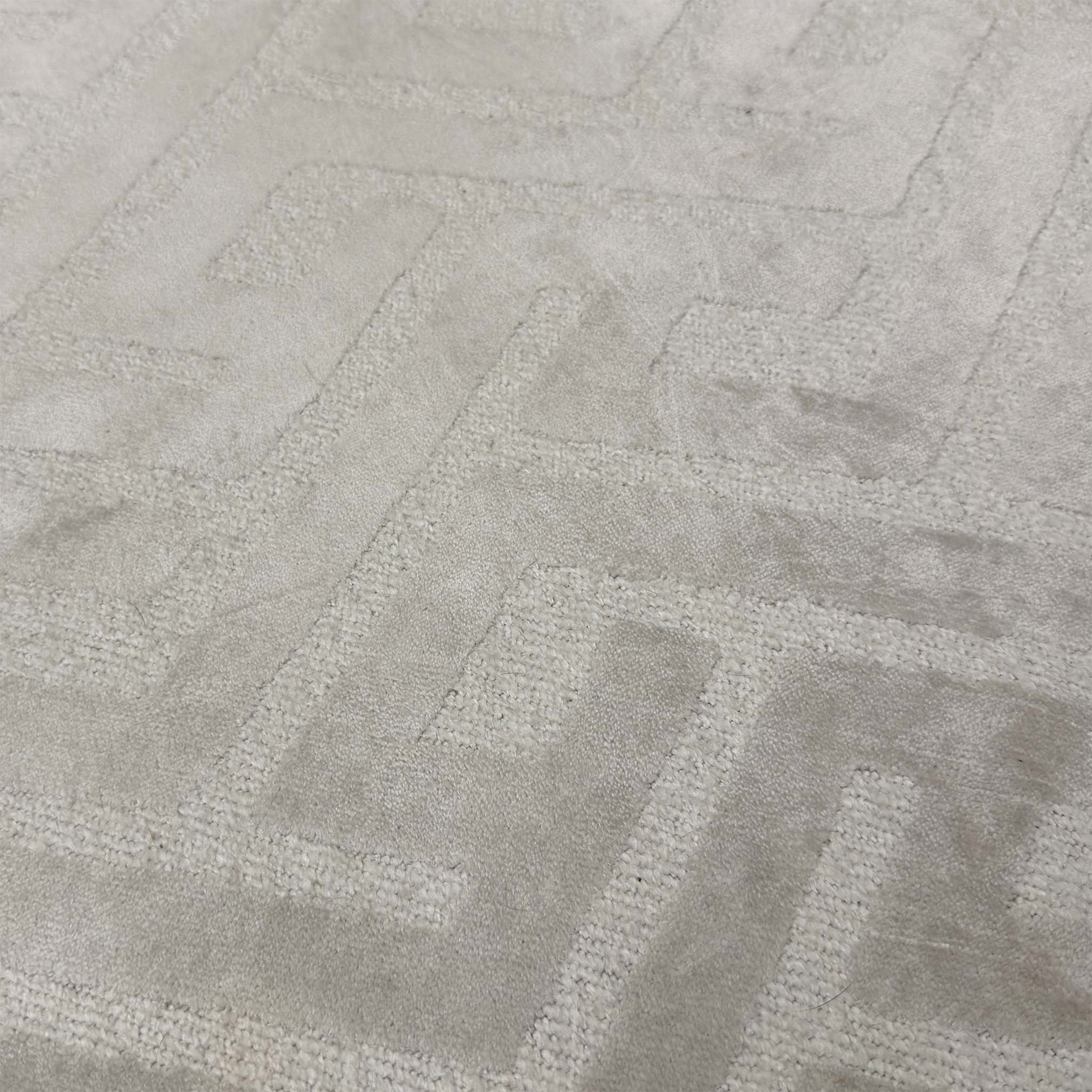Close-up of the Natural patterned fabric, highlighting the detailed weave, soft beige and cream tones, and the precision of the button detailing.