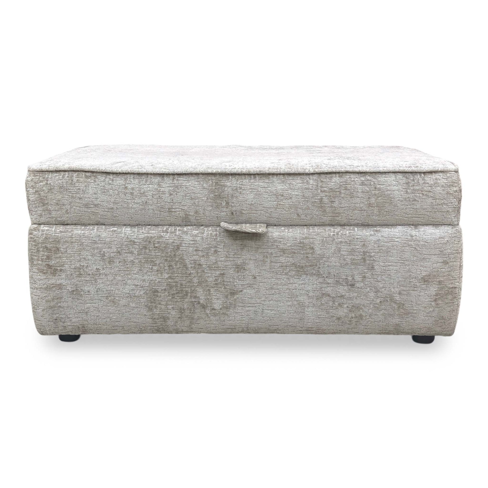 Front view shot of the discreet low-profile feet, showing the expert craftsmanship and structural stability of the footstool base.