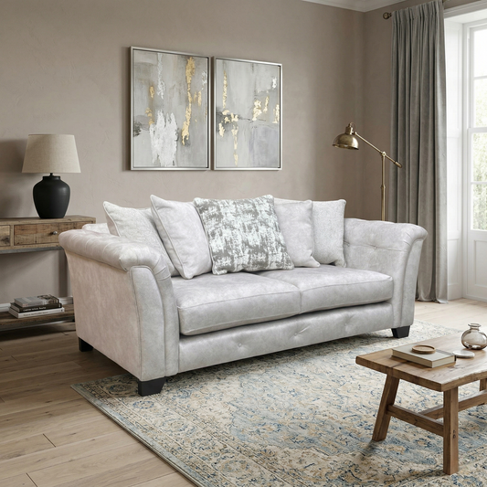 Living room view for the Aura 3-seater sofa, highlighting the luxurious Kenzo Cream velvet upholstery, plush scatter cushions, and contemporary silhouette.