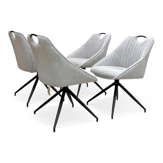 Full view of Set of 4 ‘Jai’ swivel dining chairs in Silver fabric, featuring a modern diamond-stitched backrest and sleek black tapered metal legs.