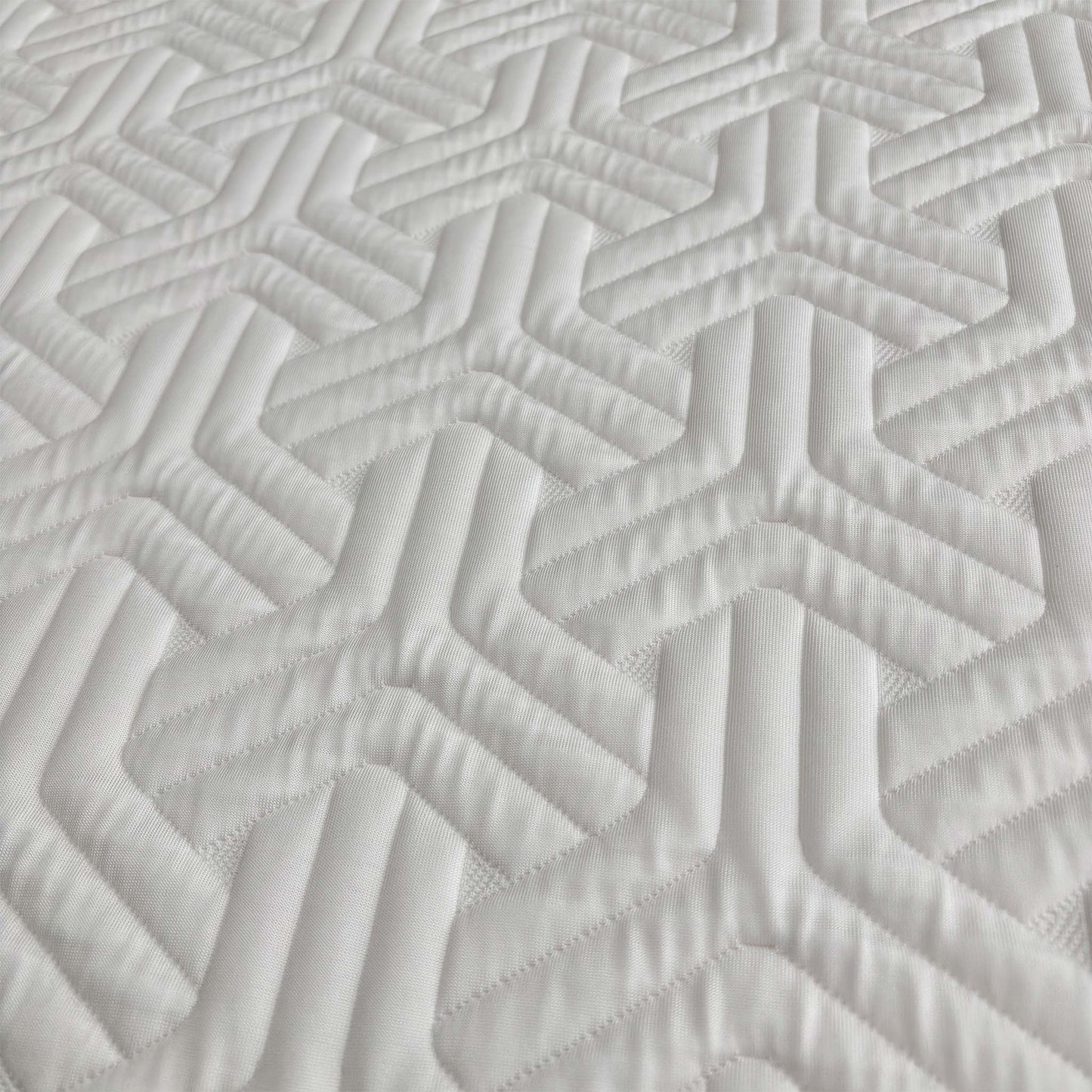 Close up view of the mattress edge, showing the 26cm depth and the durable fabric side panels designed for edge-to-edge support and longevity.