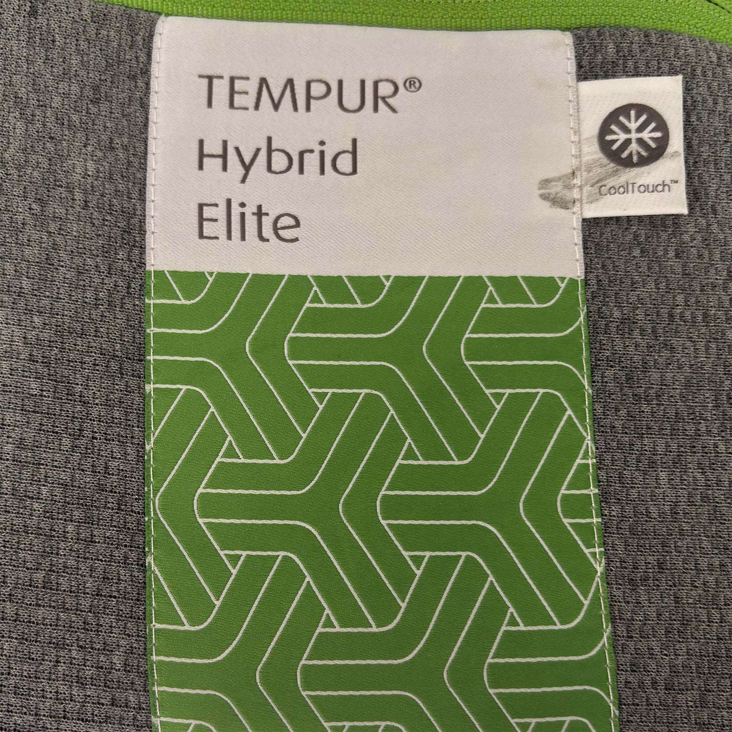 Close-up of the TEMPUR quilted mattress cover, highlighting the breathable fabric texture and the iconic TEMPUR branding on the mattress corner.
